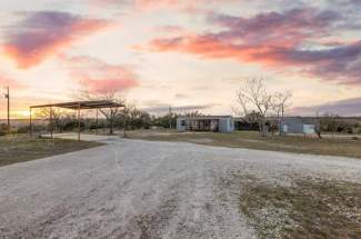 Driveway view to RV carport and guest house