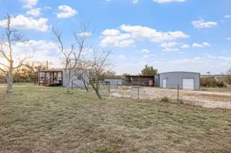 View of guest house / implement buildings / lean-to shed for livestock